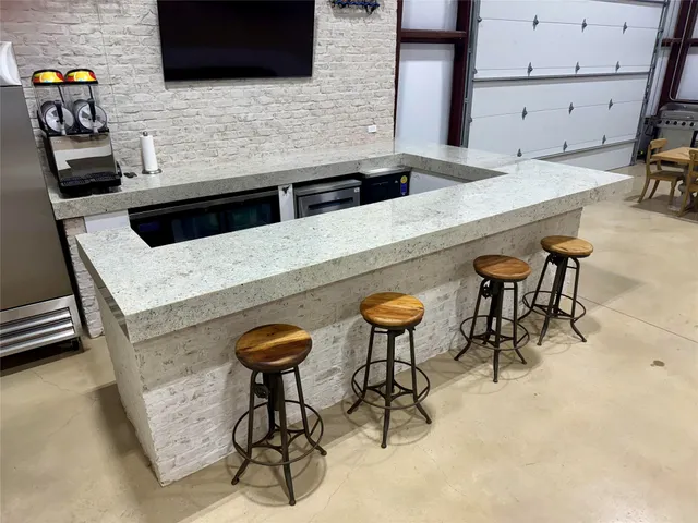 a kitchen with stainless steel appliances kitchen island a stove and a microwave