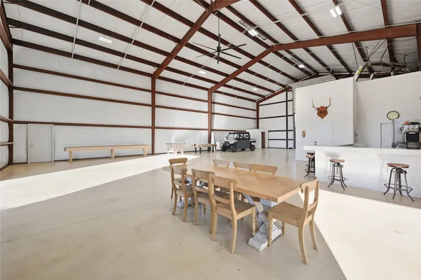 a dining room with furniture and a view of kitchen