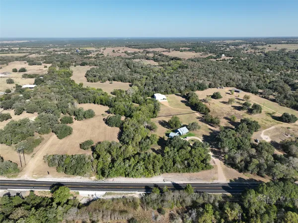 an aerial view of a house with a yard
