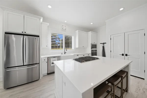 a kitchen with refrigerator a stove a sink and a refrigerator