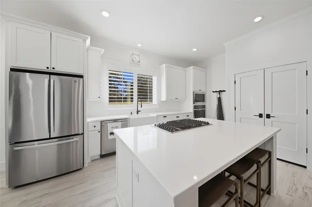 a kitchen with refrigerator a stove a sink and a refrigerator