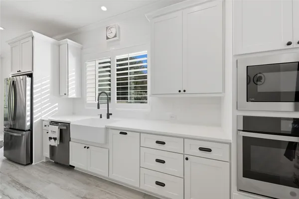 a kitchen with appliances cabinets and a sink