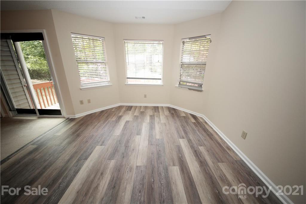 109 Ferntree Court Columbia, SC 29210 - Photo 23 of 34 an empty room with wooden floor and windows