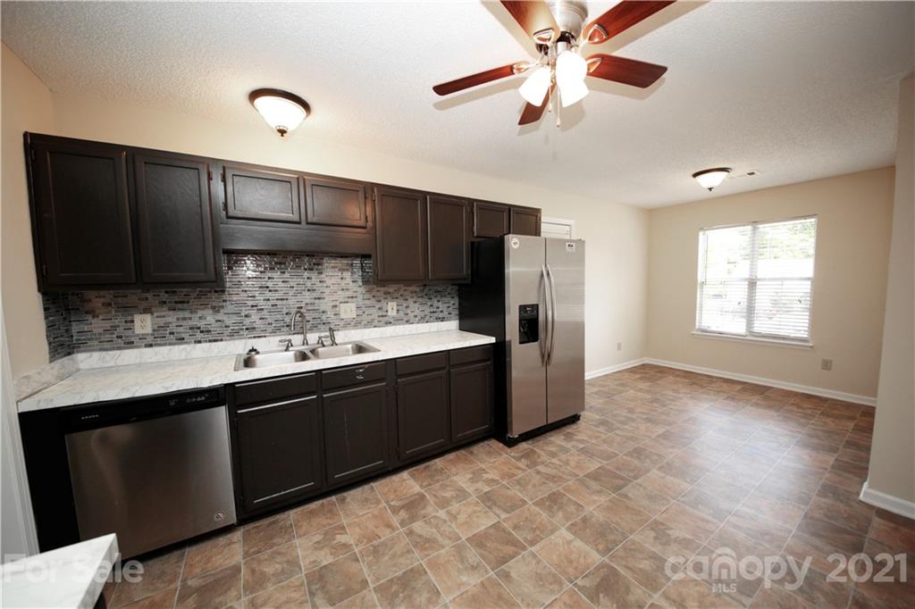109 Ferntree Court Columbia, SC 29210 - Photo 27 of 34 a kitchen with stainless steel appliances granite countertop a sink stove and refrigerator