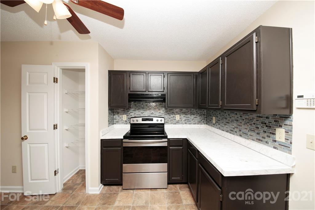 109 Ferntree Court Columbia, SC 29210 - Photo 29 of 34 a kitchen with a stove and a refrigerator