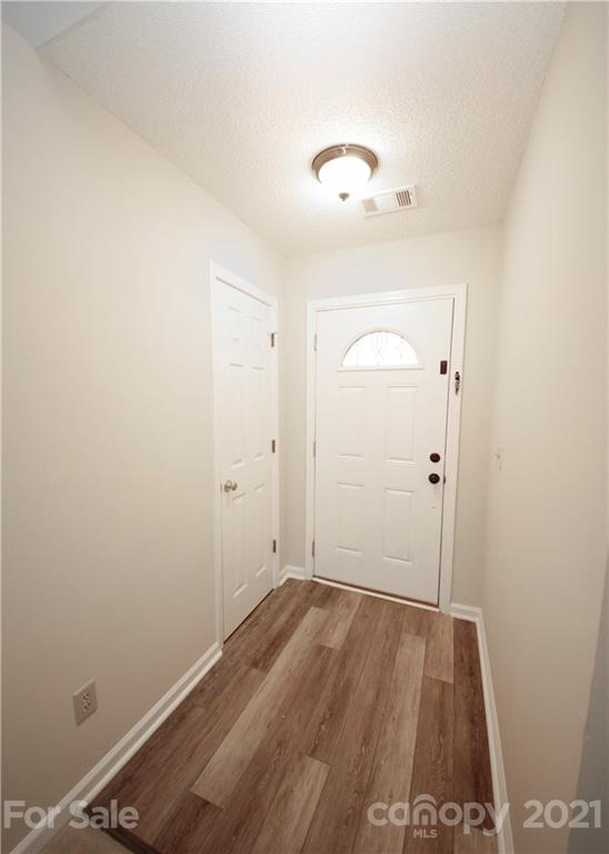109 Ferntree Court Columbia, SC 29210 - Photo 4 of 34 an empty room with wooden floor and mirror
