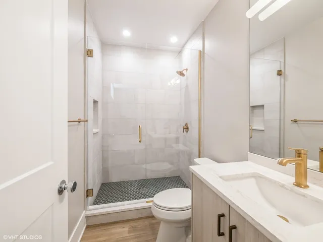a bathroom with a sink toilet and shower