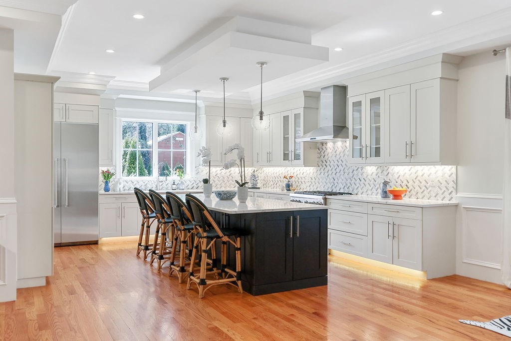 5 Sharpe Road Newton, MA 02459 - Photo 13 of 41 a kitchen with kitchen island granite countertop a sink cabinets and wooden floor