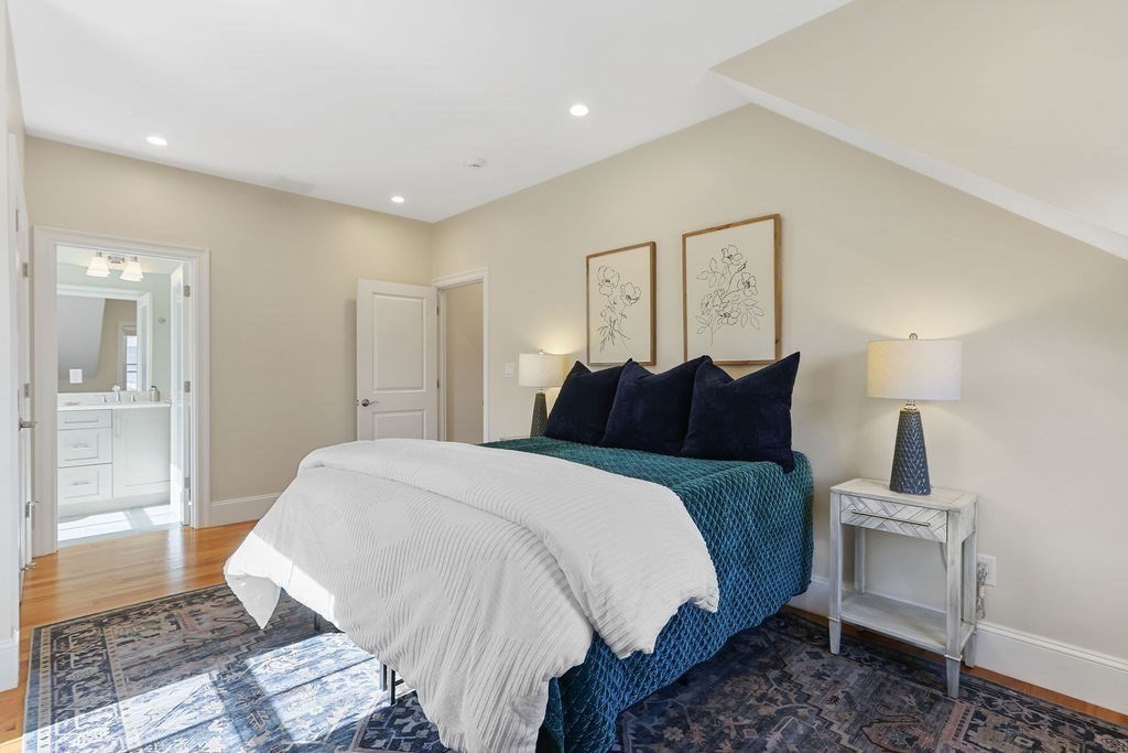 5 Sharpe Road Newton, MA 02459 - Photo 19 of 41 a spacious bedroom with a bed a mirror and lamp