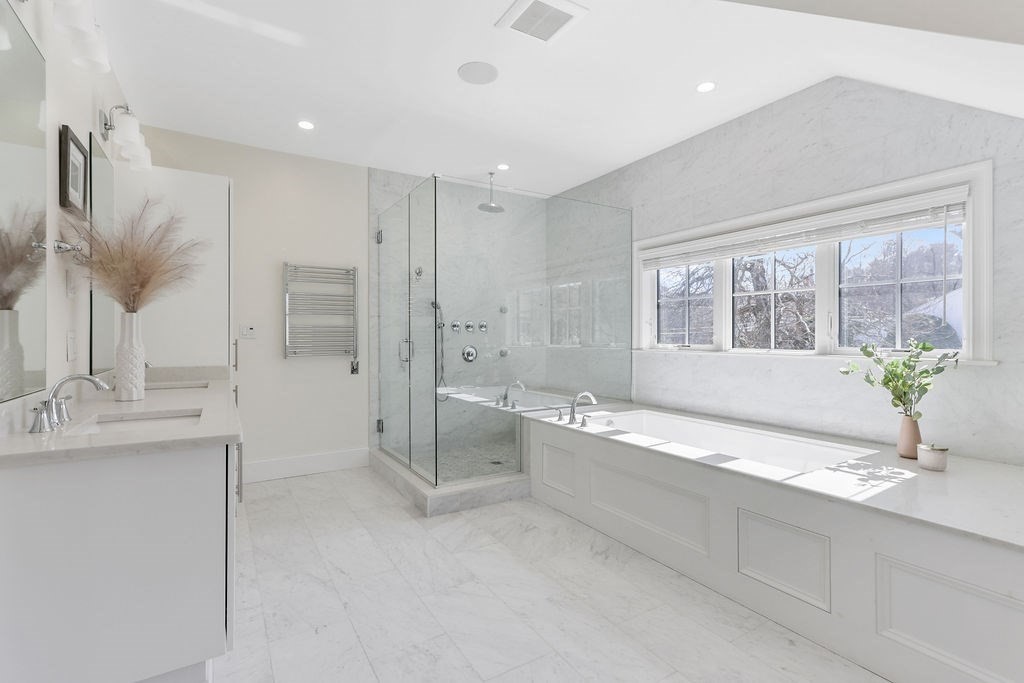 5 Sharpe Road Newton, MA 02459 - Photo 25 of 41 a spacious bathroom with a double vanity sink a large mirror a bathtub and next to a window
