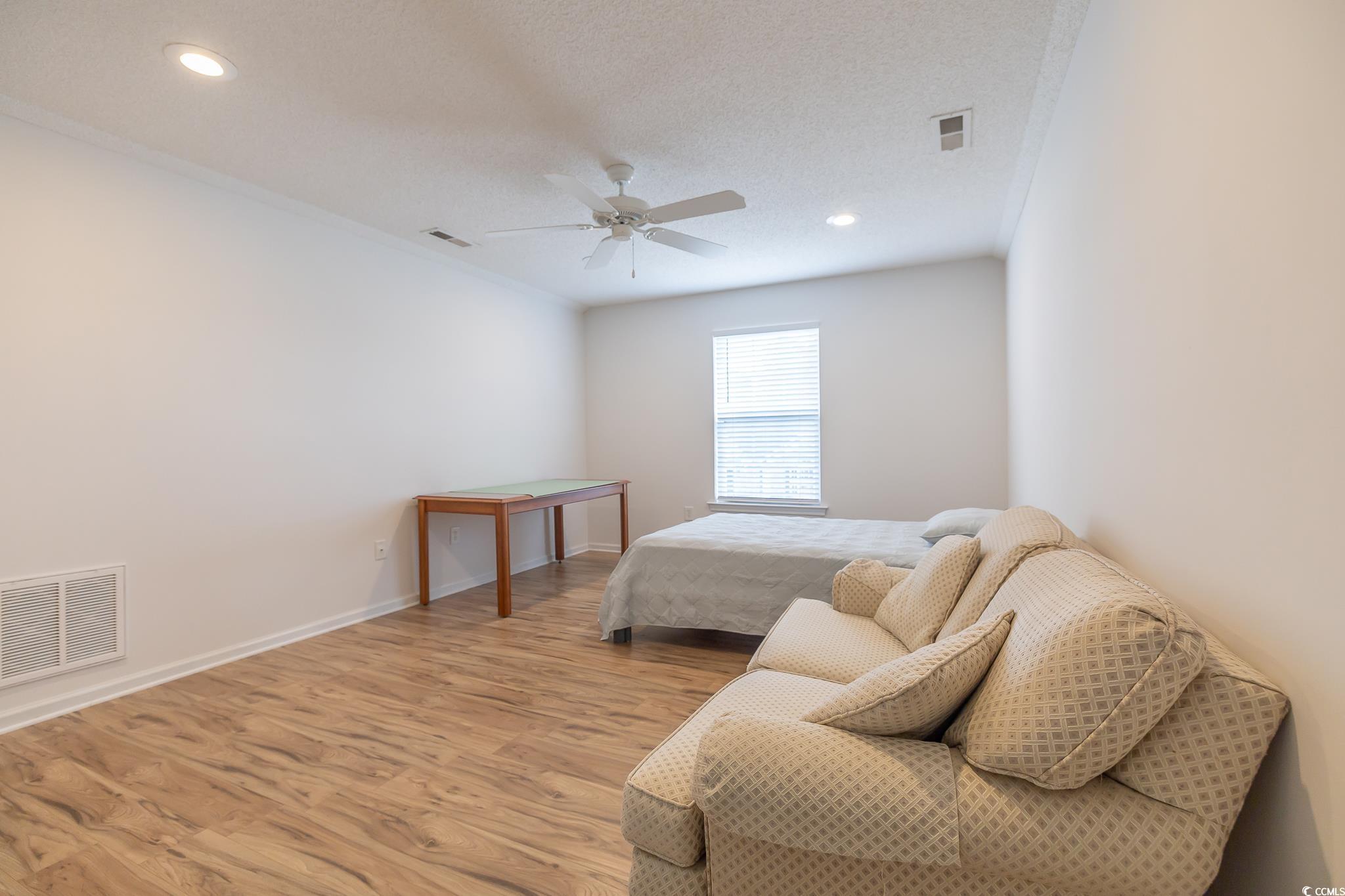 5077 Capulet Circle Myrtle Beach, SC 29588 - Photo 11 of 27 Bedroom with wood finished floors, recessed lighting, a ceiling fan, and a textured ceiling