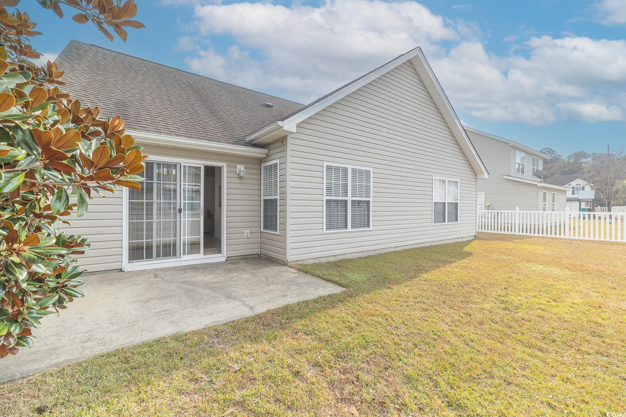 5077 Capulet Circle Myrtle Beach, SC 29588 - Photo 3 of 27 Back of house featuring a shingled roof and a patio