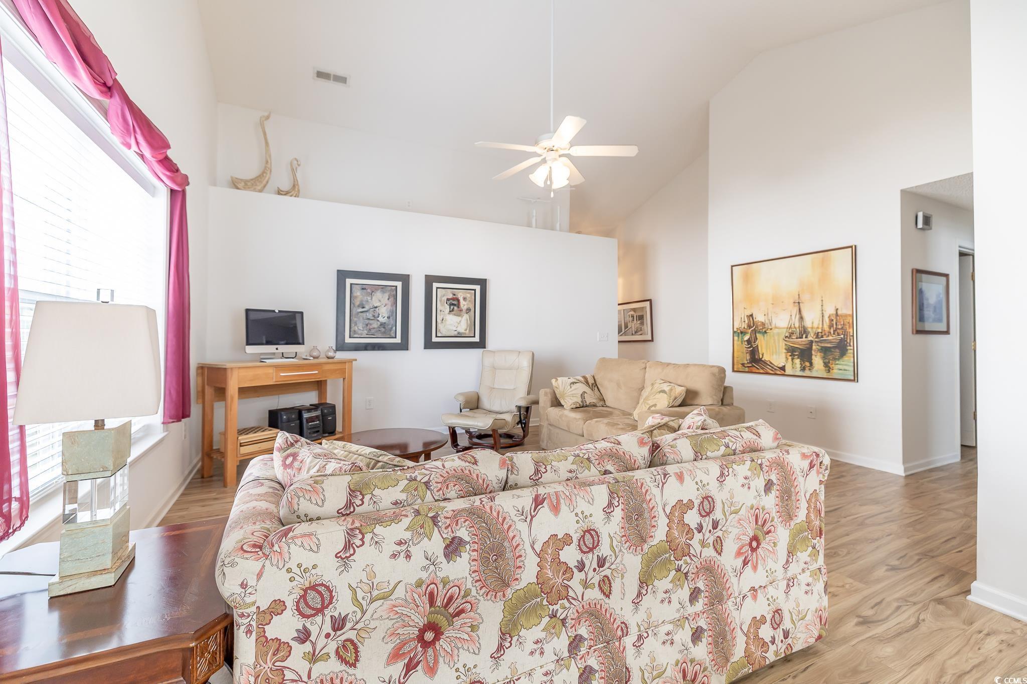 5077 Capulet Circle Myrtle Beach, SC 29588 - Photo 7 of 27 Living room with a ceiling fan, light wood-style flooring, and high vaulted ceiling