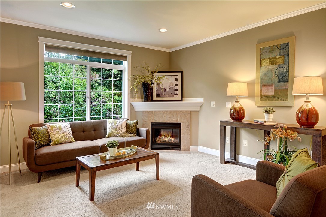907 225th Place Southeast Bothell, WA 98021 - Photo 2 of 20 a living room with furniture and a fireplace