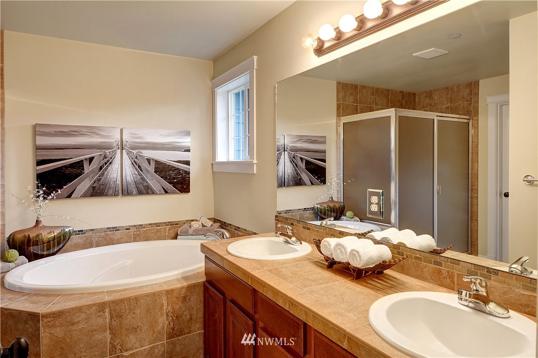 907 225th Place Southeast Bothell, WA 98021 - Photo 11 of 20 a bathroom with a granite countertop sink and a mirror
