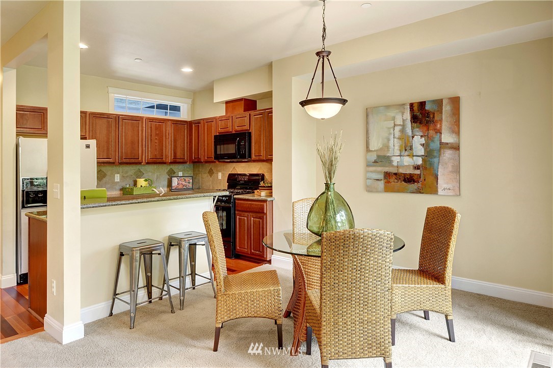907 225th Place Southeast Bothell, WA 98021 - Photo 4 of 20 a dining room with furniture a chandelier and window