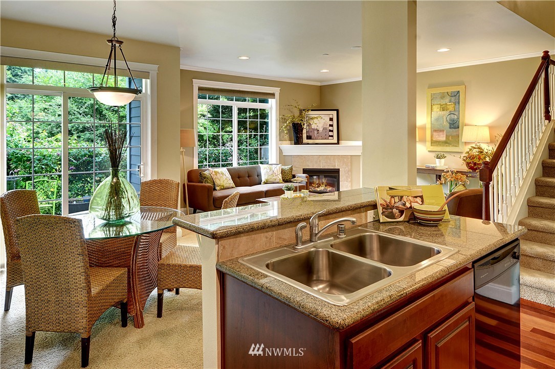 907 225th Place Southeast Bothell, WA 98021 - Photo 5 of 20 a kitchen that has a sink a table and chairs in it