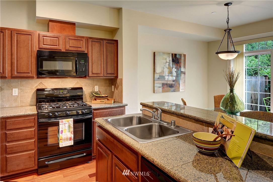 907 225th Place Southeast Bothell, WA 98021 - Photo 7 of 20 a kitchen that has a sink and a stove top oven