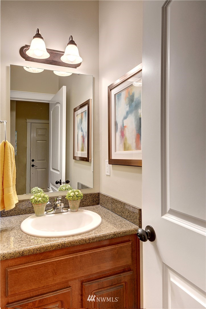907 225th Place Southeast Bothell, WA 98021 - Photo 9 of 20 a bathroom with a granite countertop sink and a mirror