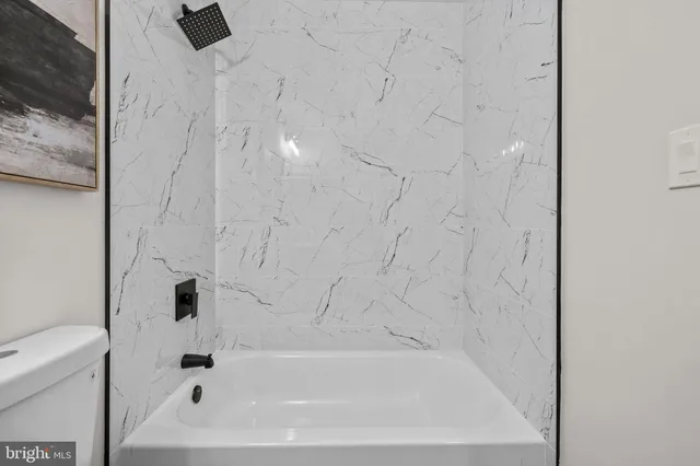 a bedroom with a large bed and a potted plant