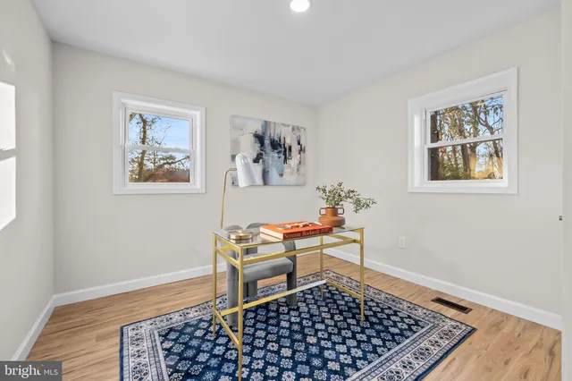 a bedroom with a large bed and a potted plant