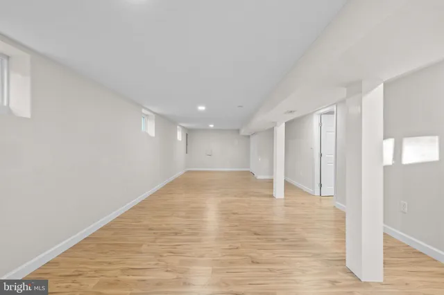 a front view of a house with a large trees