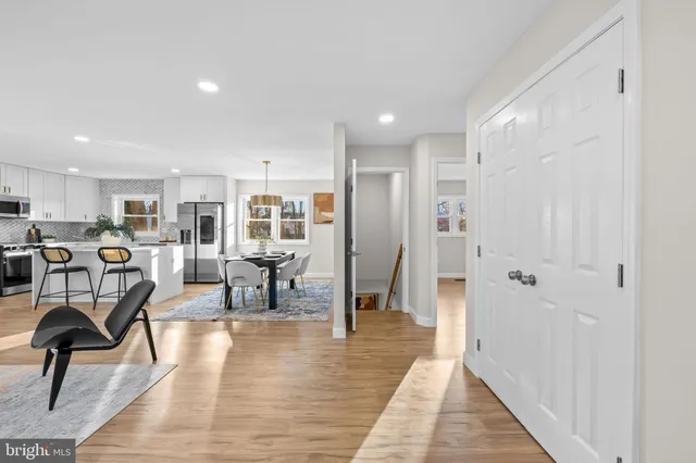 a living room with furniture and a dining table with kitchen view