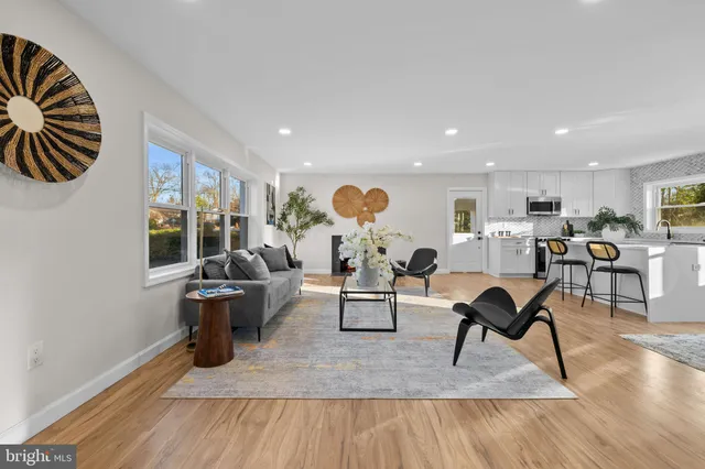 a living room with furniture a rug and a fireplace