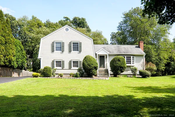 a front view of house with yard and green space