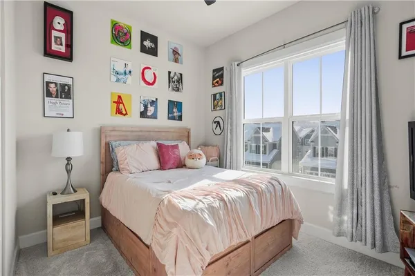 a bedroom with a bed and a large window with the outer view