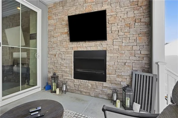 a living room with a fireplace and a flat screen tv