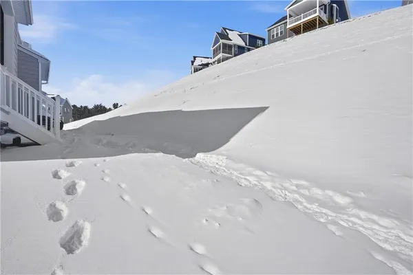 a view of a house with a snow in the middle of a yard