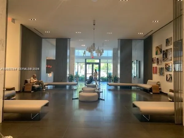a lobby with furniture and floor to ceiling window