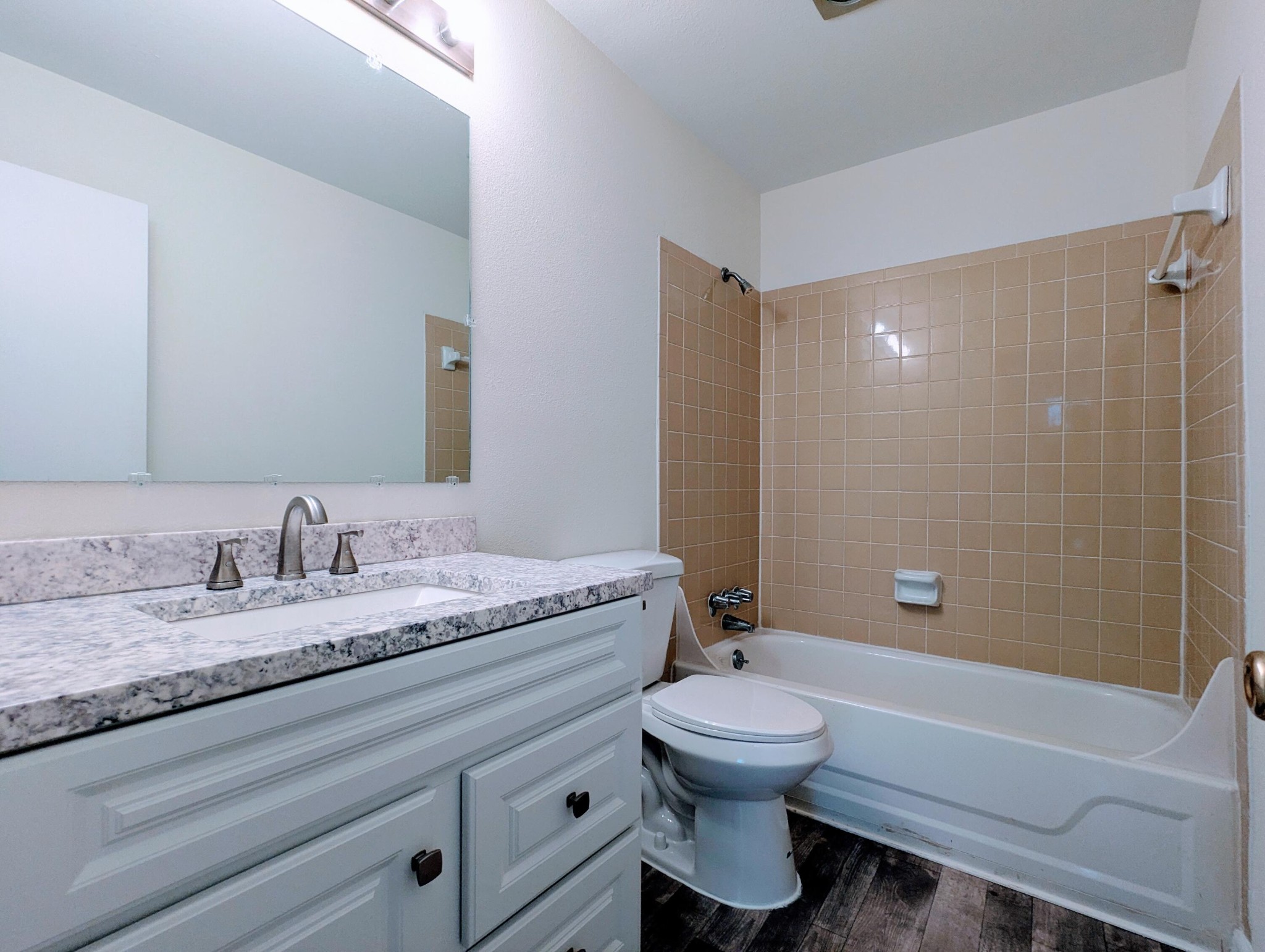 900 Mountain Creek Road, Unit 38 Chattanooga, TN 37405 - Photo 12 of 14 a bathroom with a granite countertop toilet a sink and bathtub