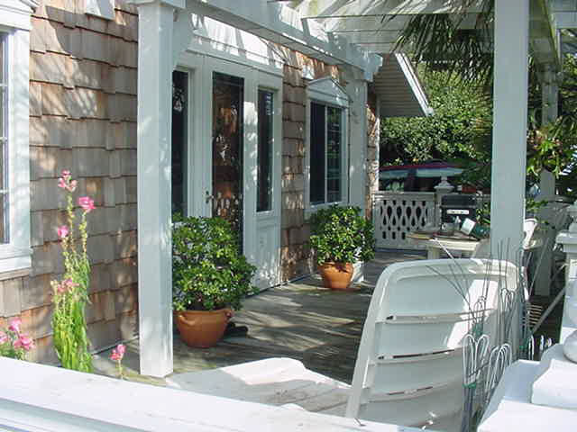 255 Garfield Street Santa Rosa Beach, FL 32459 - Photo 1 of 26 a view of a patio with table and chairs potted plants