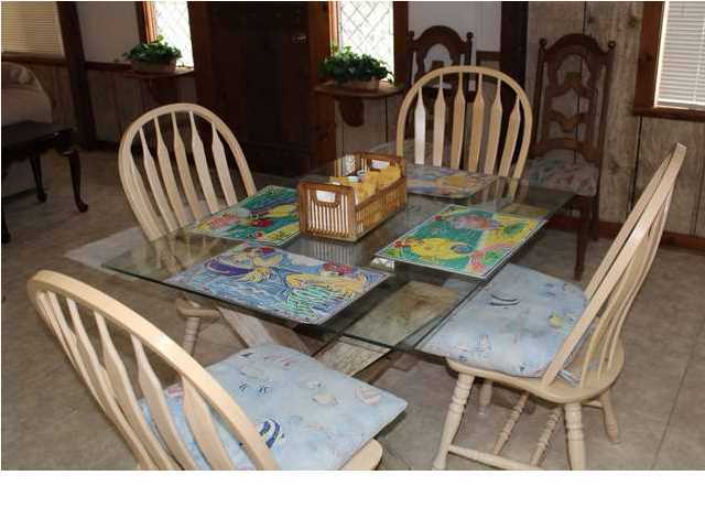 255 Garfield Street Santa Rosa Beach, FL 32459 - Photo 20 of 26 a view of a dining table and chairs in patio