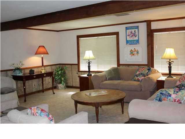 255 Garfield Street Santa Rosa Beach, FL 32459 - Photo 21 of 26 a living room with furniture and a lamp