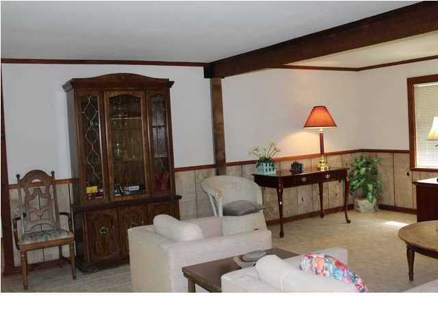 255 Garfield Street Santa Rosa Beach, FL 32459 - Photo 22 of 26 a living room with furniture and a lamp