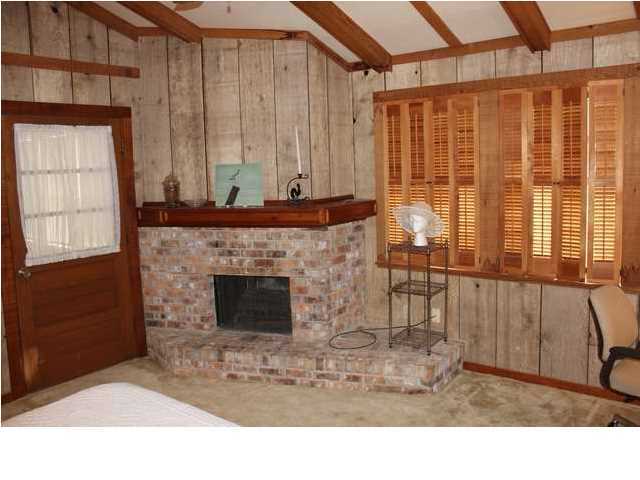255 Garfield Street Santa Rosa Beach, FL 32459 - Photo 26 of 26 a living room with a fireplace furniture and a large window