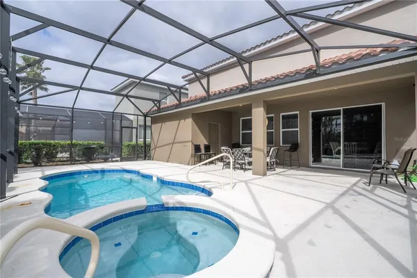 a swimming pool with outdoor seating and yard