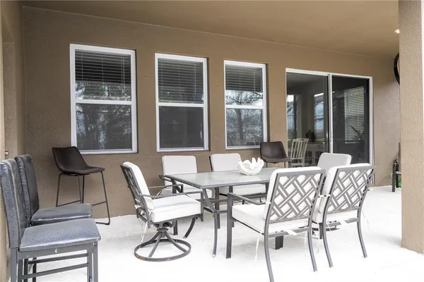 a view of a dining room with furniture wooden floor and windows