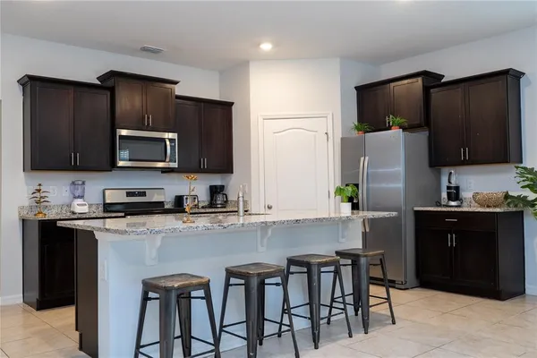 a kitchen with stainless steel appliances granite countertop counter space a sink and cabinets