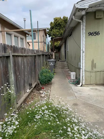 a backyard of a house with table and chairs