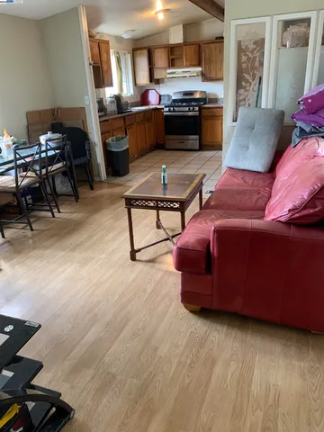 a living room with furniture and kitchen view