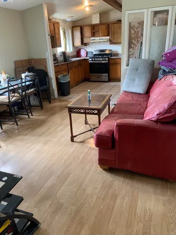 a living room with furniture and kitchen view