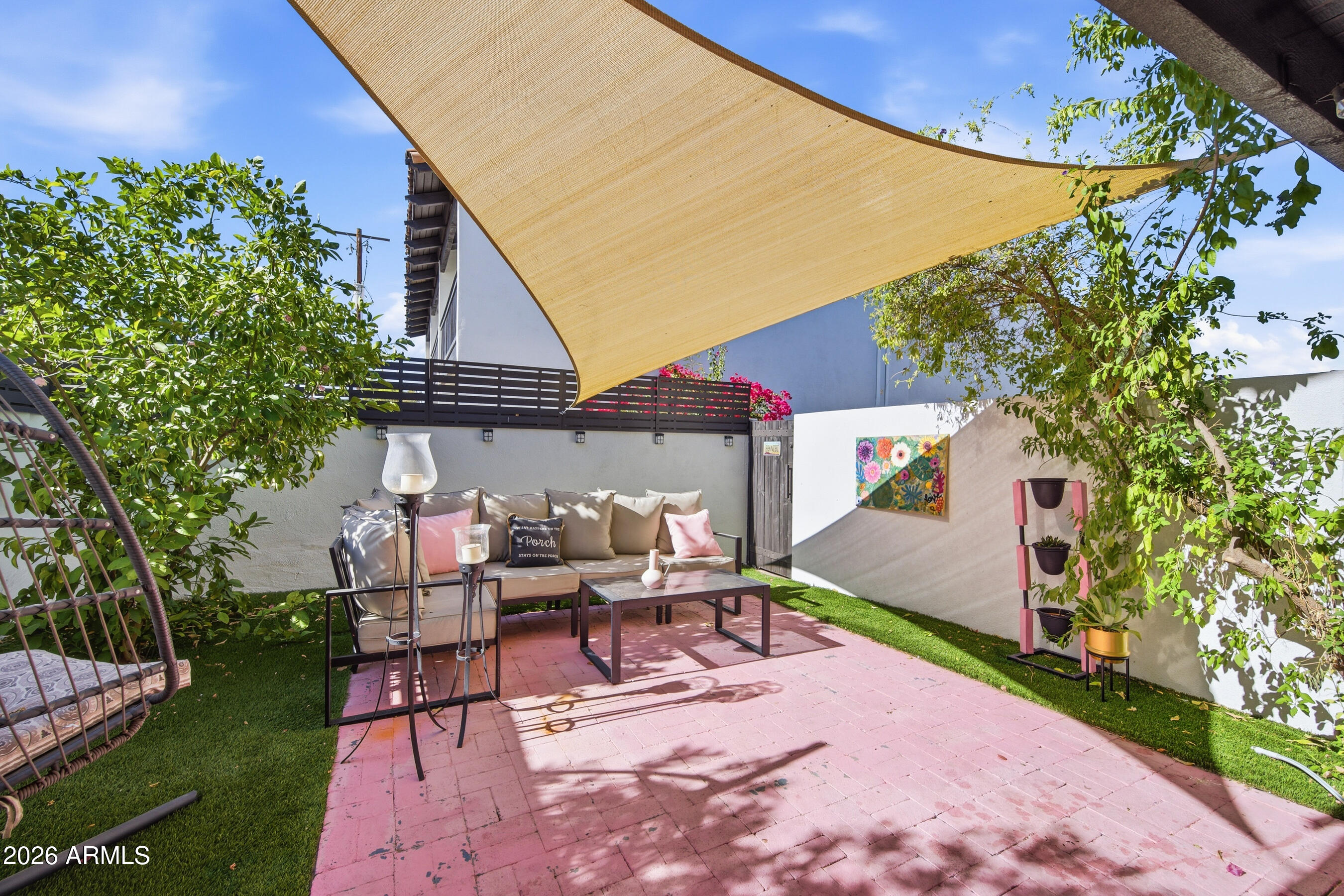 1702 East Ocotillo Road, Unit 1 Phoenix, AZ 85016 - Photo 25 of 27 a view of a patio with a table and chairs under an umbrella