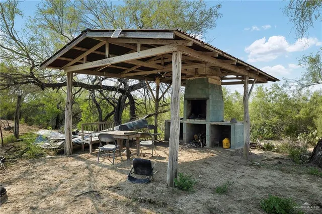a view of house with backyard and seating space