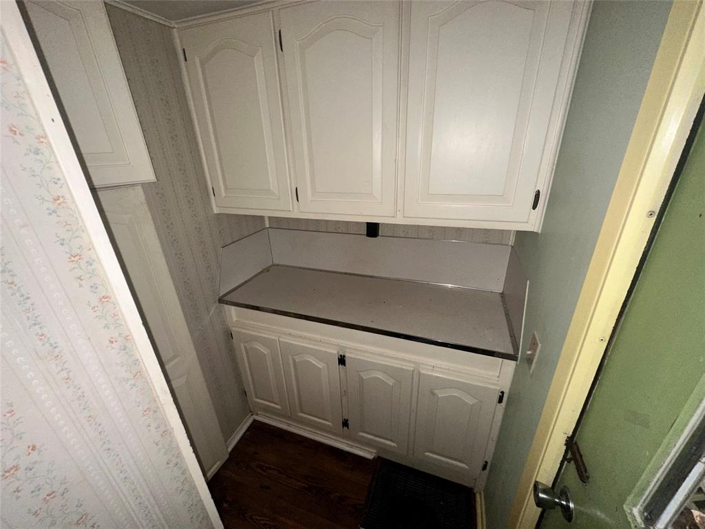 1832 Smokehouse Road Granbury, TX 76049 - Photo 19 of 23 Kitchen with white cabinetry and dark hardwood / wood-style flooring