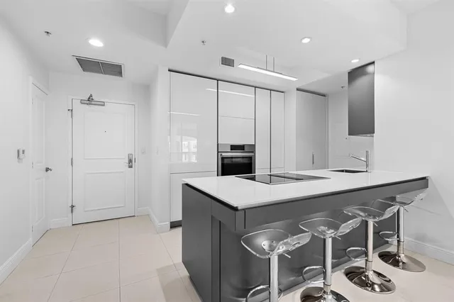 a kitchen with a table and chairs in it