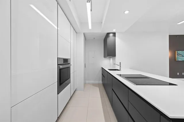 a kitchen with granite countertop a sink and stainless steel appliances